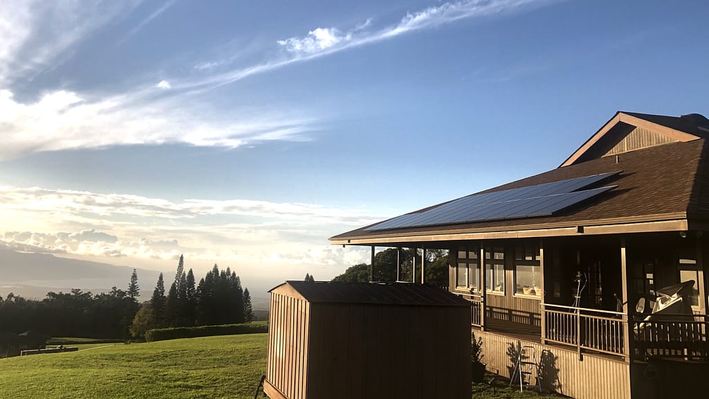 blue sky and brown gray house using solar power