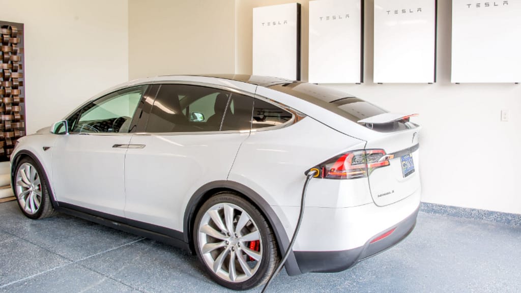 electric  white vehicle charging with Tesla Powerwall