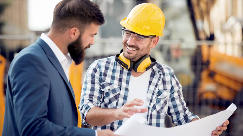 monitoring the solar project progress with professional wearing yellow hard hat