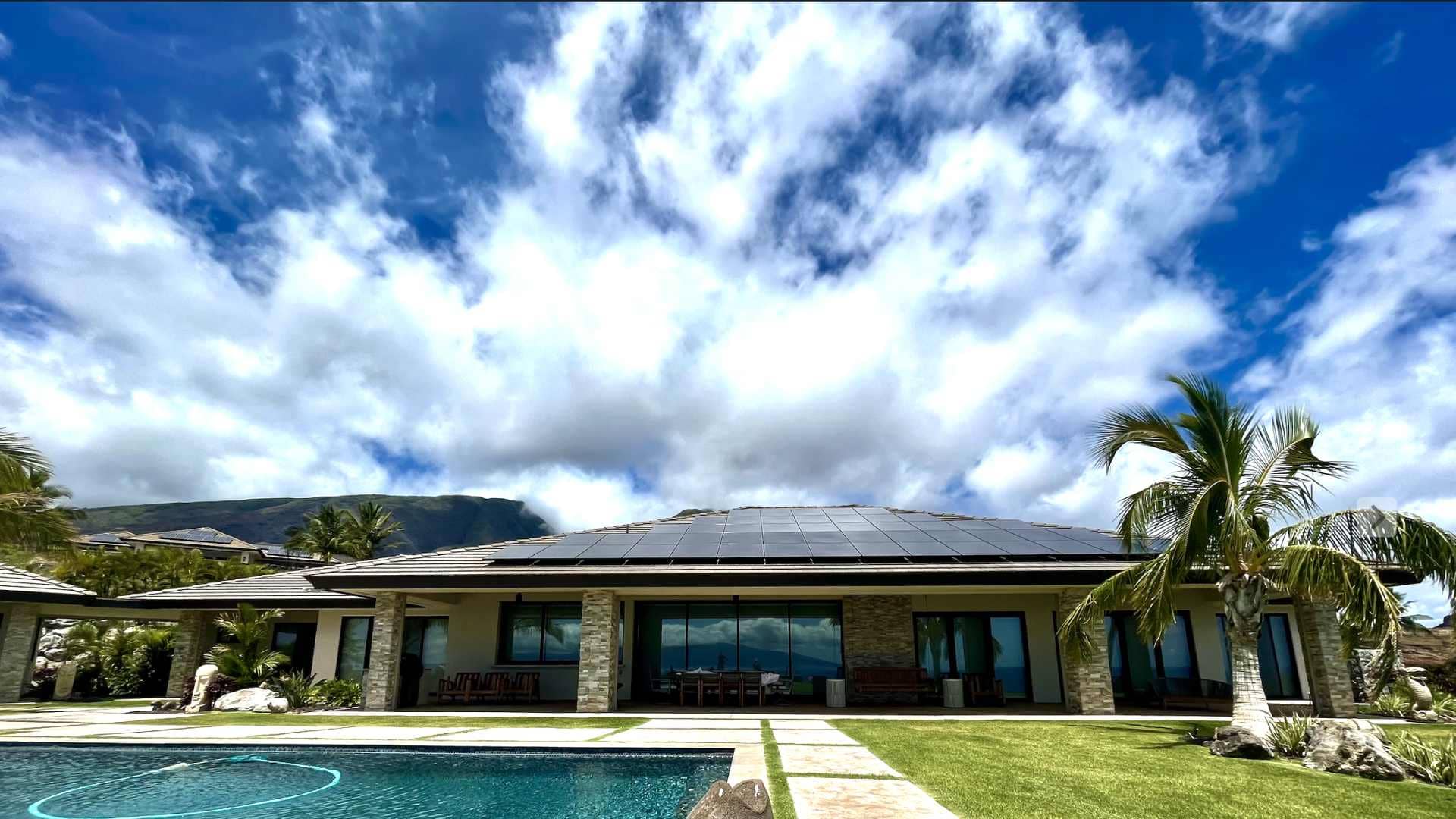 beautiful house with solar roof and pool inside the yard