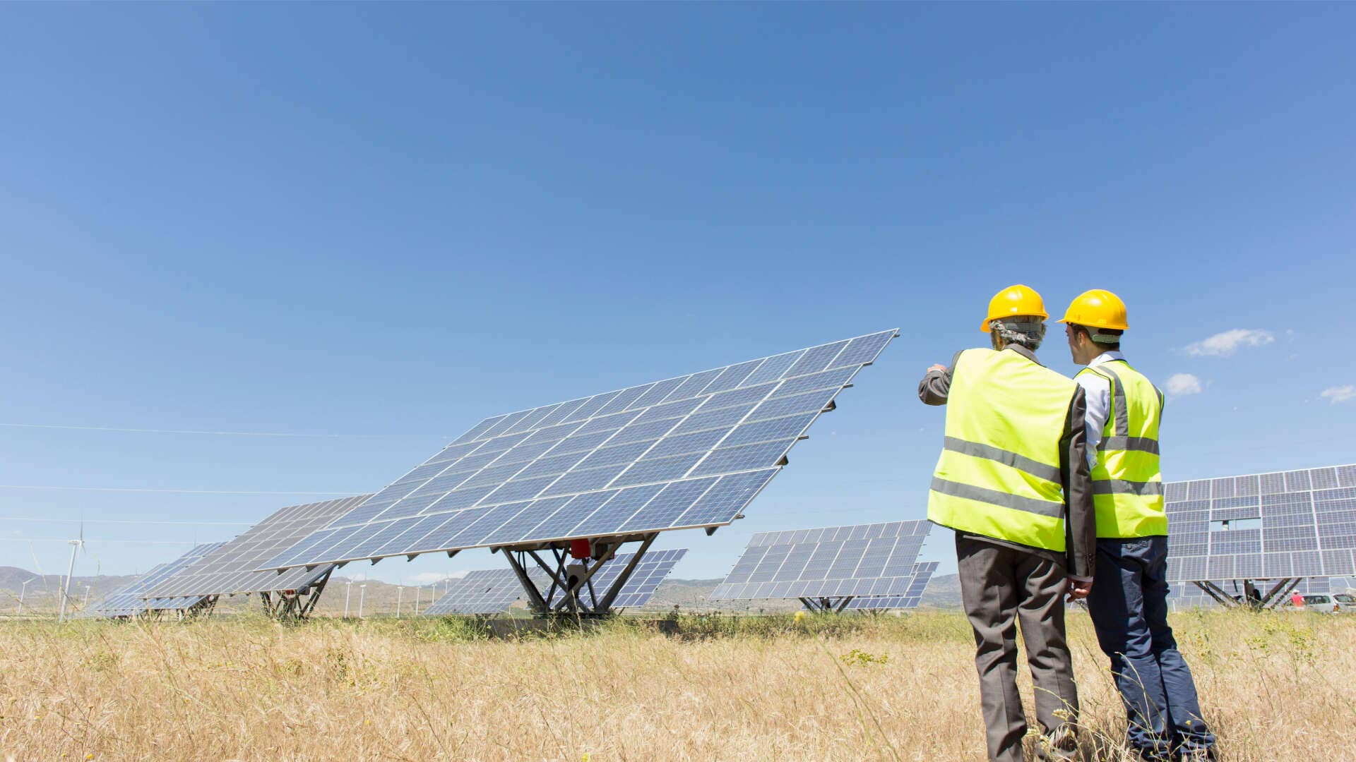 two professionals checking solar panels